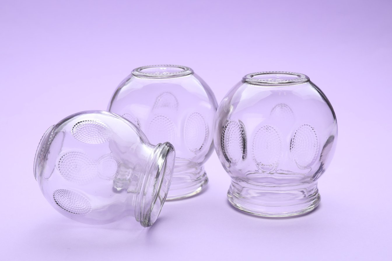 Glass Cups on Violet Background. Cupping